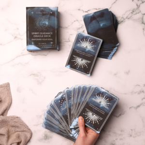Hand holding Spirit Guidance Oracle Deck on marble surface during a soulful Stillness reading ritual