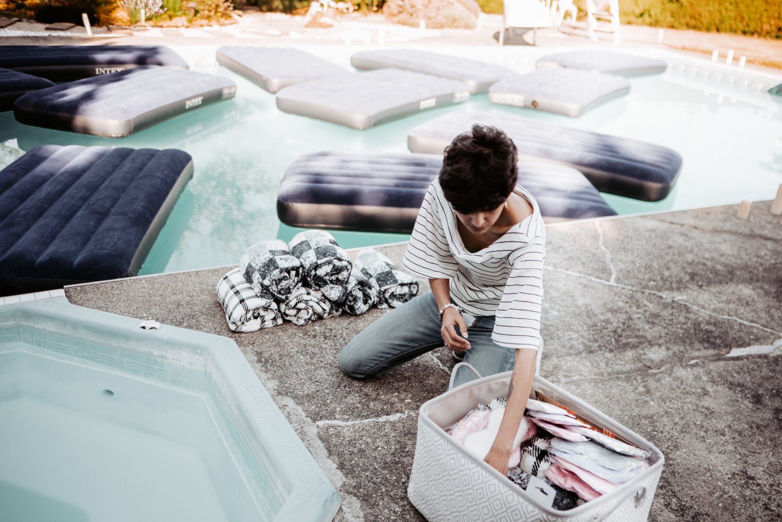 Komal holding space poolside during a floating sound bath