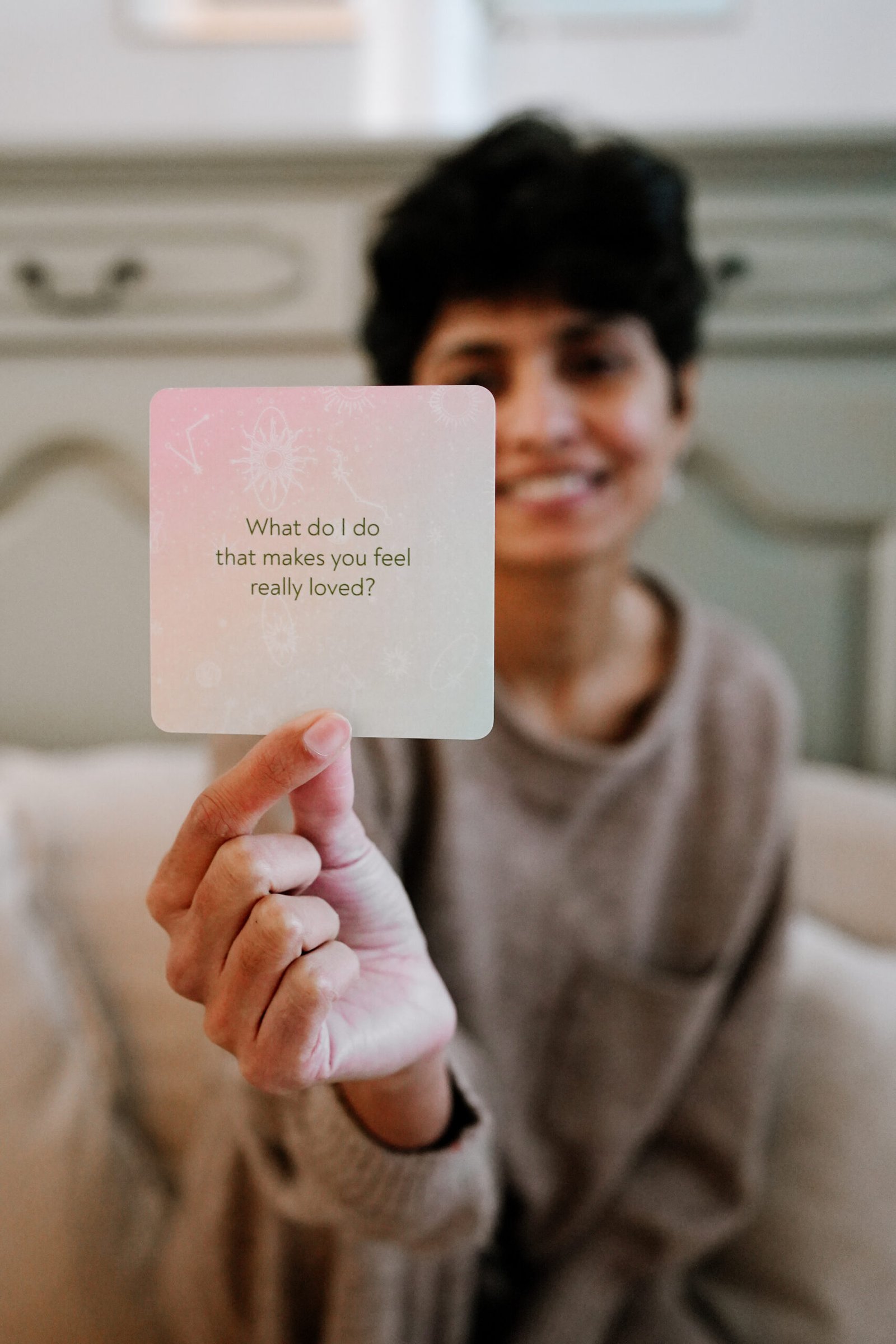 Komal holding an In This Little Life card